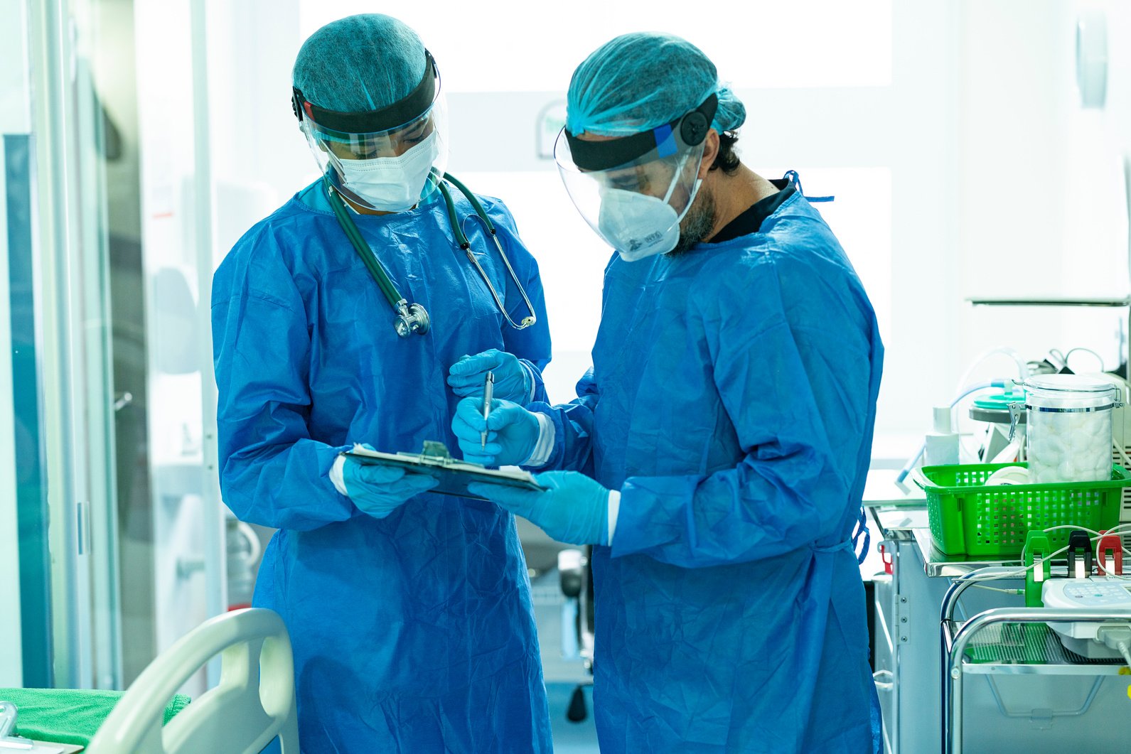 couple of doctors talk while wearing their biosecurity suits in the hospital ICU